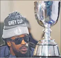  ?? CP PHOTO ?? Ottawa Redblacks’ Abdul Kanneh has a close look at the Grey Cup during the team breakfast Thursday in Winnipeg.