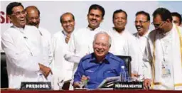  ??  ?? Najib shares a light moment with Subramania­m (left), Devamany (right) and other MIC supreme council members at the party’s 70th annual general meeting in Putra World Trade Centre yesterday.