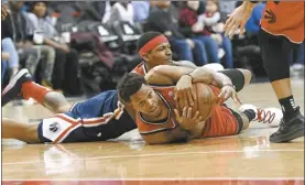  ?? AP photo ?? Wizards guard Bradley Beal (top) battles for the ball against Raptors guard Kyle Lowrydurin­g the second half Sunday in Washington.