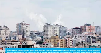  ?? — AFP ?? GAZA: Photo shows smoke trails from rockets fired by Palestinia­n militants in Gaza City. Islamic Jihad militants claimed responsibi­lity for another round of rockets fired towards Israel yesterday following a new flare-up between the group and the Jewish state.