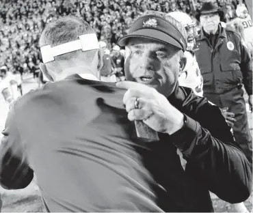  ?? [PHOTO BY STEVE SISNEY, THE OKLAHOMAN ARCHIVES] ?? TCU coach Gary Patterson and Oklahoma coach Lincoln Riley hug after OU’s win last season in Norman.