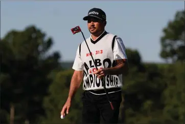  ?? GEORGE WALKER IV — THE ASSOCIATED PRESS ?? Jason Day, of Australia, waves after making a putt on the 18th hole during the weather delayed first round round at the Masters golf tournament at Augusta National Golf Club Friday, April 12, 2024, in Augusta, Ga.