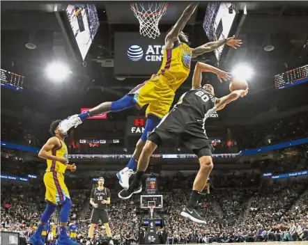  ?? — AP ?? High flying act: San Antonio Spurs guard Manu Ginobili (right) attempting to score past Golden State Warriors centre Jordan Bell during their NBA basketball match on Monday. San Antonio won 89-75.
