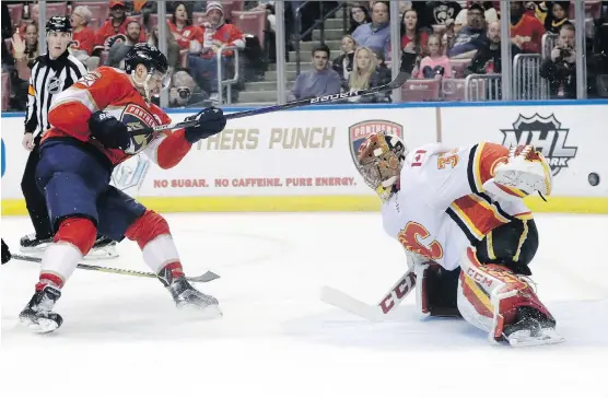  ?? LYNNE SLADKY/ THE ASSOCIATED PRESS ?? Panthers forward Aleksander Barkov had his scoring attempt foiled by Calgary goaltender David Rittich as the Flames won 4-2 Friday in Sunrise, Fla.
