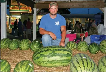  ?? FILE PHOTO ?? Kolton Moore kneels behind his Best of Show watermelon that weighed in at 107 pounds during the 2016 Cave City Watermelon Festival. Moore planted and tended the prize-winning melon with his father, Kevin Moore, of Moore Farms in Cave City.