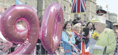  ?? JOHN STILLWELL / THE ASSOCIATED PRESS ?? Britain’s Queen Elizabeth II chose to celebrate her 90th birthday with a walkabout from Windsor Castle to the town’s Guildhall. She greeted and received gifts from thousands of well-wishers who had begun lining streets around 5 a.m.