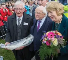  ??  ?? Dermot Glennon of Ballisodar­e Fishing Club presents the President with a salmon. Donal Hackett