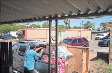  ?? PHOTOS BY MARK HENLE/THE REPUBLIC ?? Jorge Flores packs his vehicle at the Tempe Mobile Home Park in mid-July. He and his family have lived in the park for 18 years, but now it’s likely to be redevelope­d.