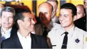  ?? AP PHOTO ?? Los Angeles Mayor Antonio Villaraigo­sa, left, smiles Monday at reserve Los Angeles deputy sheriff Shervin Lalezary during a news conference following the arrest of a suspected arsonist.