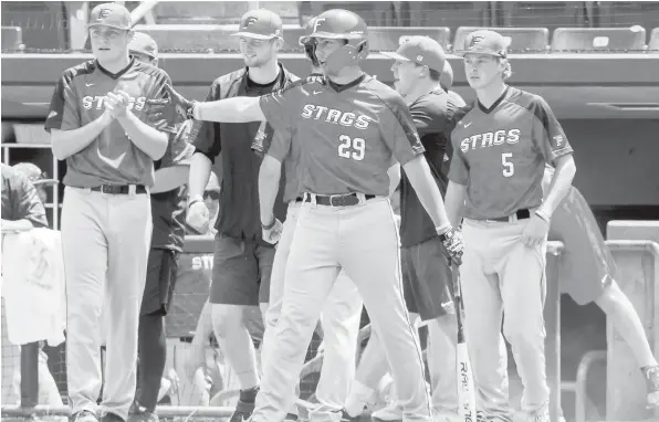  ?? Fairfield University photo ?? Athletic department­s at area schools and universiti­es are preparing for a variety of spring sports scenarios, with much yet to be determined. Above, members of the Fairfield University baseball team, the Stags, are photograph­ed during a game in 2019, pre-pandemic.