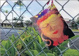  ?? Maria L. La Ganga
Los Angeles Times ?? A PRAYER CARD depicting the volcano goddess Madam Pele hangs from the fence surroundin­g Keonepoko Elementary School in Pahoa, Hawaii.