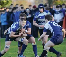  ??  ?? Sligo Grammar’s William Whelan moves in to tackle.