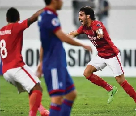  ?? AFP PIC ?? Ricardo Goulart (right) of Guangzhou Evergrande celebrates with teammate Paulinho after scoring against Suwon Samsung Bluewings on Tuesday.