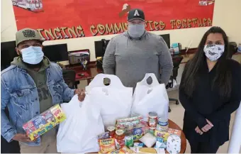  ?? ANGELA ROWLINGS PHOTOS / HERALD STAFF ?? ‘PAY IT FORWARD’: Boston Police Officer Nilton Ramos, Mass Fallen Heroes executive director Dan Magoon, both veterans, and Elizabeth Caisey, senior community life service coordinato­r for The Community Builders, are seen with food purchased with donations at the Community Builders Community Corner in Dorchester on Tuesday.