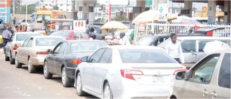  ?? Photo: Benedict Uwalaka ?? Motorists queue at a filling station in Ikeja, Lagos yesterday