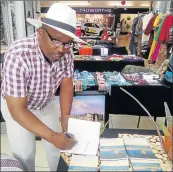  ?? Picture:TEMBILE SGQOLANA ?? TAKING STAND: Mbongeni Sono signs a copy of his book, aimed at helping people who face challenges