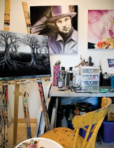  ??  ?? A portrait Meghan Sims painted to honour Gord Downie of the Tragically Hip looks over her workspace, which includes the tubes of paint placed in order based on how she perceives the colours.