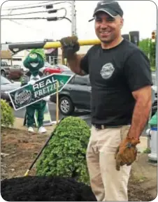  ??  ?? Joe Chiarello does some landscapin­g at his new Philly Pretzel Factory location in Southampto­n. Chiarello, a Holland resident, also owns a Philly Pretzel Factory in Richboro.