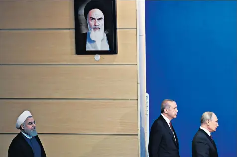  ??  ?? Hassan Rouhani, Recep Tayyip Erdogan and Vladimir Putin after meeting in Tehran for the summit on Idlib yesterday