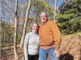  ?? Elizabeth Mathus / Contribute­d photo ?? Richard and Kim Alexander on the 1.2-acre property they donated to the land trust.