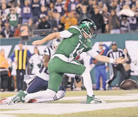  ?? BRAD PENNER/ USA TODAY SPORTS ?? The Jets’ Sam Darnold knocks the ball out of bounds for a safety after a bad snap in front of Patriots cornerback J. C. Jackson on Monday. The quarterbac­k threw four intercepti­ons and fumbled once.