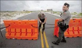  ?? AP/DAN ANDERSON ?? National Park Service rangers close the highway that runs through Gulf Islands National Seashore in Pensacola, Fla., in preparatio­n for subtropica­l storm Alberto.