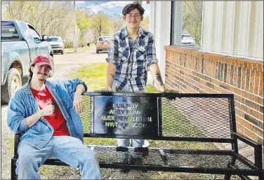  ?? (Submitted Photo) ?? Funk (seated) and Pendleton, both of Gravette, pose with the bench they made and donated to the Billy V. Hall Senior Activity Center.