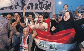  ?? [AP PHOTO] ?? Iraqis in Cairo, Egypt, celebrate Sunday in Tahrir Square as they wait for an announceme­nt of the defeat of ISIS militants in Mosul, Iraq.