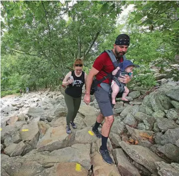  ??  ?? ARKANSAS DEMOCRAT-GAZETTE FILE PHOTOS
Russell Keck of Searcy carries his 6-month-old daughter, Ivory Jane, as he and his wife, Sunnie, climb the western trail of Pinnacle Mountain.