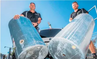  ?? PHOTO / PAUL TAYLOR ?? Owner of Peak Plumbing & Gas Ltd Grayson Allen (left) and apprentice plumber Michael Kaijser with a pair of wrecked copper hot water cylinders.