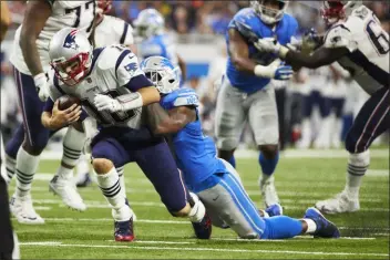  ?? RICK OSENTOSKI — THE ASSOCIATED PRESS ?? Eli Harold, right, sacked Patriots quarterbac­k Tom Brady not once by twice in a game last September. That apparently didn’t endear him to the Lions, which is why he’s competing for snaps with the Eagles this summer.