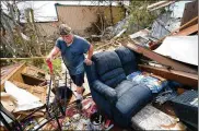  ?? AP ?? Bradley Beardwalks with a shovel through his daughter’s destroyed trailerhom­e, after searching in vain for the water shutoffval­ve for the property in the aftermath of Hurricane Laura on Saturday inHackberr­y, La.