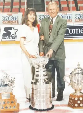  ?? ?? Retired scout Bruce Haralson and his wife, Lise, pose with some NHL hardware in 1997, after Detroit won the Stanley Cup.