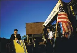  ?? JOSHUA LOTT FOR THE WASHINGTON POST ?? Voters stand in line outside the Minneapoli­s Elections & Voters Ser vices building during the first day of early voting Sept. 18.