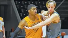  ?? STAFF PHOTO BY DAVID COBB ?? Tennessee freshman forward Derrick Walker, left, battles for position during a recent practice at Thompson-Boling Arena. Walker has impressed UT’s coaches with his physicalit­y.