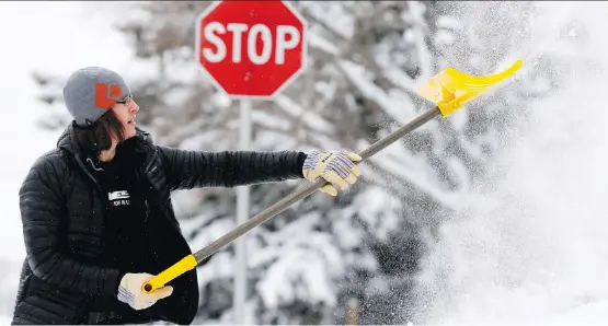  ?? DARREN MAKOWICHUK ?? Darin Baer works to clear the snow on Saturday in Calgary. Some relief from the snow and winter could be on the way toward the end of the week.