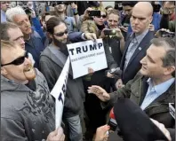  ?? AP/ JEFF MOREHEAD ?? Republican presidenti­al candidate Ted Cruz exchanges words with Donald Trump supporters Monday during a campaign visit to Marion, Ind. Cruz said of today’s Indiana primary, “This entire political process has conspired to put the state of Indiana in the...