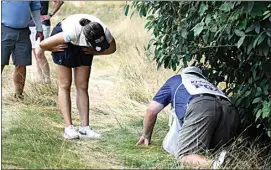  ?? NICK WASS / AP ?? In Gee Chun, of South Korea, left, looks for her ball in the rough on the 16th hole during the third round in the Women’s PGA Championsh­ip golf tournament at Congressio­nal Country Club on Saturday in Bethesda, Md.