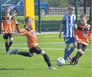  ??  ?? Foot through it! DUSC Age 10s were in action against Blairgowri­e (blue) on the Craigie 3G.