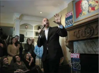  ?? STEVEN SENNE — THE ASSOCIATED PRESS ?? U.S. Sen. Cory Booker, D-N.J., addresses a crowd during a campaign stop, Sunday at a home, in Manchester, N.H.