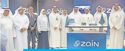  ??  ?? KUWAIT: Dr Ali Al-Mudhaf with Zain officials at the company’s booth.