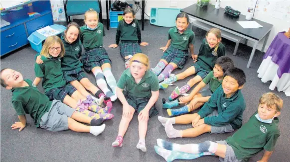  ?? Photo / Ilona Hanne ?? Keeley Bell, 9, (centre) was the centre of attention on Monday when tamariki in Redwood Room at St Patricks School in Inglewood rocked their diversity by wearing colourful odd socks.