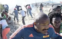  ?? PICTURE: PHANDO JIKELO ?? EVICTED: Police used stun grenades to disperse a group of land invaders in Makhaza, Khayelitsh­a, yesterday.