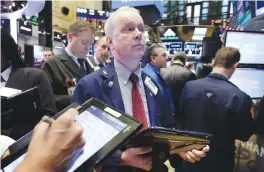  ??  ?? NEW YORK: Trader James Riley works on the floor of the New York Stock Exchange on Friday.—AP