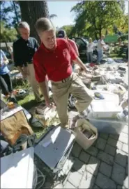  ?? JOHN BAZEMORE — AP PHOTO ?? Republican candidate for president Sen. Lindsey Graham, R-S.C., climbs over debris as he tours a neighborho­od damaged by flooding, Wednesday, in Columbia, S.C.