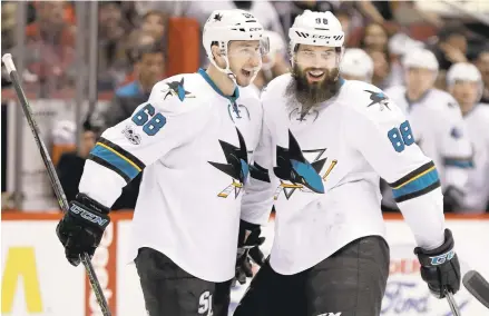  ?? CHRIS CARLSON/ASSOCIATED PRESS ?? Sharks defenseman Brent Burns, right, celebrates with center Melker Karlsson after scoring in the first period against Arizona on Saturday.