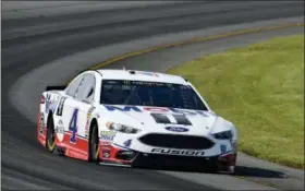  ?? DERIK HAMILTON — THE ASSOCIATED PRESS ?? Kevin Harvick drives through Turn 3 during qualifying for Sunday’s NASCAR Cup Series auto race, Saturday in Long Pond, Pa. Harvick qualified on the pole, but his car failed post-qualifying inspection, and he will start at the rear of the field.