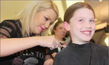  ??  ?? Rachel Durnin cutting Doireann Conlon’s hair in The Eclips Hair Salon, Longwalk Shopping Centre.