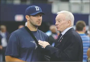  ?? The Associated Press ?? END OF AN ERA: This Oct. 11, 2015, photo shows Dallas Cowboys owner Jerry Jones, right, talking with quarterbac­k Tony Romo before an NFL game against the New England Patriots in Arlington, Texas. Jones honored DeMarcus Ware with the announceme­nt that...