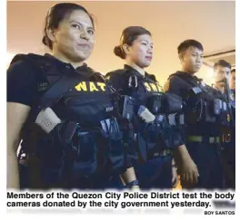  ?? BOY SANTOS ?? Members of the Quezon City Police District test the body cameras donated by the city government yesterday.